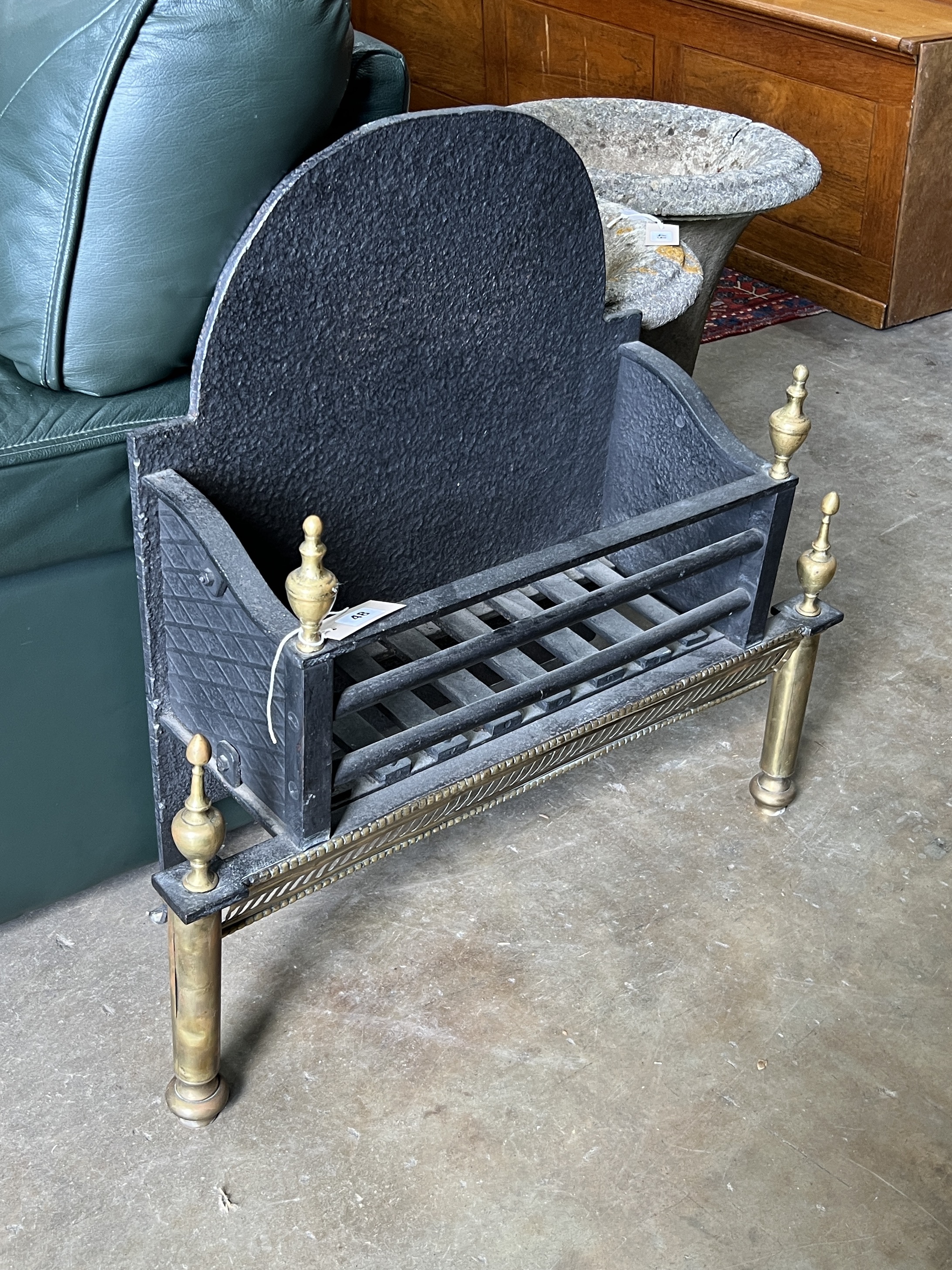 A brass mounted cast iron fire grate, width 71cm, depth 24cm, height 70cm